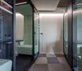 glass walls, green chairs, checkered floor, control panel, small table