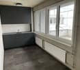kitchen with cabinets, sink, window, radiators, tiled floor