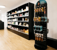 Hair salon with shelves full of products and tools, wooden floor