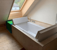 wooden ceiling, bathtub, sink, window, tiled wall, purple rug, towel