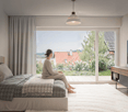 Bed on white platform, wooden floor, sliding glass door to balcony, TV mounted on wall, floor to ceiling windows, person sitting on bed