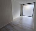 Marble tiles flooring, white walls, large glass panel, empty room