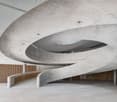 modern building, spiral staircase, white tile flooring, exposed concrete walls, open space