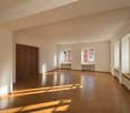 empty room, wooden floors, large windows, heating, arched doors