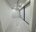 empty hallway with white walls, black sliding doors, recessed lighting, tiled floor