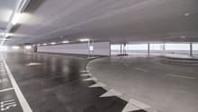 Underground parking lot with designated parking spaces and lane markings.