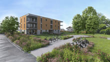 Modern apartment building with balconies, surrounded by greenery and flowers, bicycles parked in front
