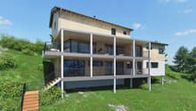 2 story wooden house, concrete balcony, green grassy hill