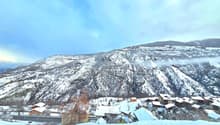 Snowy mountains, several houses, village