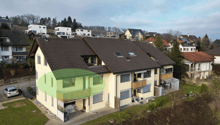 2 story house, brown roof, yellow walls, balcony, car parked in front
