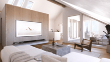 Living room with sky windows, large flat screen TV, white couch, white coffee table, white carpet, glass sliding doors