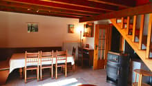 dining room with wooden table and chairs, radiator, wooden stairs, fireplace