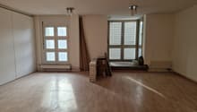 empty room, wooden floor, white walls, two windows, two sets of lights
