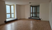 empty room, wooden floor, large windows, white walls, ceiling lights