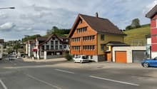 Houses on the street, brown roof, yellow walls, garage, cars parked in front