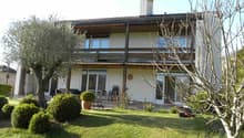2 story house, white exterior, balcony, garden, lawn, trees, shrubs, lawn mower
