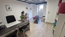 Office room with desk, chairs, treadmill, shelves, picture frame, and a plant