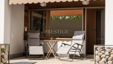 Terrace with two lounge chairs, small table, and view of outdoor surroundings