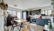 Open-plan kitchen and dining area with modern appliances and wooden floor