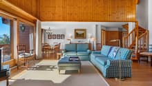 / a living room with a couch and chairs in it