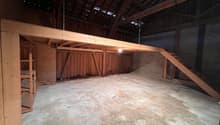 empty room, wooden beams, concrete floor, wooden shelves, wooden stairs