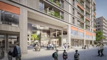 Multi-storey residential building with balconies, entrance with lighting, glass walls, outdoor seating area, paved square