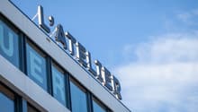 Modern multi-story building with large windows and the name 'Lufthansa' prominently displayed on the facade.