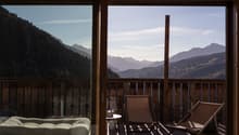 Wooden railing, outdoor furniture, open to terrace with view of mountains