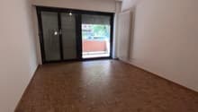 empty room, wooden floor, sliding glass door, white walls, white radiator, ceiling light
