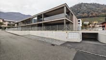 multistory house, modern architecture, glass windows, concrete fence, garage, parking lot