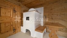 wooden walls, wooden door, white fireplace, wooden bench, wooden table