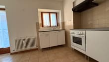 modern minimalist kitchen, white cabinets, tiled floor, gas stove, sink, wooden window frame, white radiator