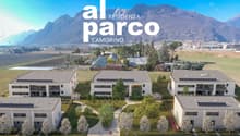 The image shows a residential complex called 'Al Parco Residenza' located in Camorino. The complex consists of several multi-story buildings with balconies and a large green area with trees and landscaping. There appear to be parking spaces available on t