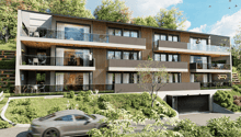 3-story modern apartment building with wood and glass facade, balconies, and a garage on the ground level. The building is surrounded by lush greenery and trees.