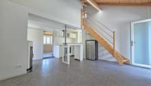 open floor plan, wooden ceiling, white walls, gray floor, kitchen, staircase, refrigerator, fireplace