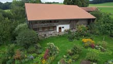 traditional wooden house, tiled roof, front garden with lawn and plants, wooden door