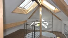 attic room with spiral staircase and skylight