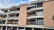 4 story apartment building, multiple balconies, underground garage