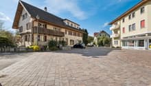 3 story house, brick facade, wooden balcony, brick driveway