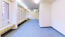 Empty room, white walls, blue carpet, windows, benches, lamps