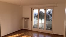 empty room, wooden floor, white walls, sliding glass doors, balcony, radiator
