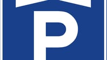 Parking sign, indicating a parking lot or garage
