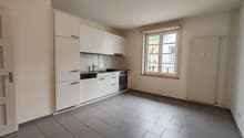 White cabinets, grey tiled floor, sink, faucet, oven, dishwasher, dishwasher, window with view
