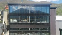 modern office building, glass facade, multiple floors, construction site