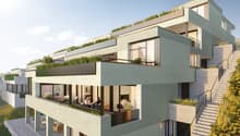 Modern multi-story building with green roofs, balconies, and terraces