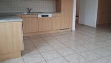 modern kitchen with wooden cabinets, granite countertops, stainless steel sink, dishwasher, tiled floor