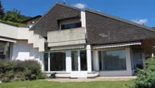 Modern white house, brown roof, terrace, garden, glass windows, shrubs