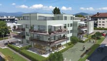Apartment complex, multiple floors, balconies on each floor, community playground