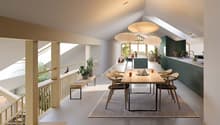 The image shows an open concept living, dining, and kitchen area with a modern and minimalist design. The space features high ceilings, large windows that provide natural light, and a wooden dining table with chairs. The kitchen area has green cabinets an