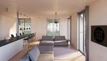modern design, large windows, gray couches, round rug, kitchen island, bar stools, pendant lights, black sign